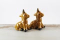 Pair of golden brown horse/donkey salt and pepper shakers on white background.