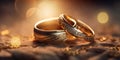 A pair of gold wedding rings with diamonds. Bokeh background