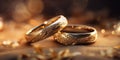 A pair of gold wedding rings with diamonds. Bokeh background