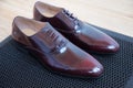 A pair of good beautiful and expensive men`s shoes. The concept of success and style. Maroon.