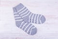 Pair of gray woolen socks on white wooden background Royalty Free Stock Photo