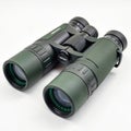 Pair of Green and Black Binoculars with Focus Wheel on White Background optics optical instrument Royalty Free Stock Photo