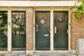 a pair of green doors on a brick building Royalty Free Stock Photo