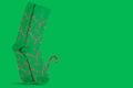 Pair of green socks with santa claus staff template, stand on green background, copy space