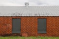 grey painted over windows red brick warehouse building Royalty Free Stock Photo