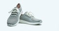 A pair of grey shoes on white background. Comfortable shoes with pore. Breathable rubber shoes. Footwear