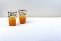 A pair hand crafted yellow orange vintage drinking glasses