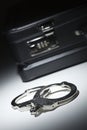 Pair of Handcuffs and Briefcase Under Spot Light Royalty Free Stock Photo