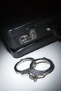 Pair of Handcuffs and Briefcase Under Spot Light Royalty Free Stock Photo