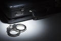 Pair of Handcuffs and Briefcase Under Spot Light Royalty Free Stock Photo