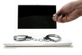 Pair of handcuffs on the keyboard front of a computer screen