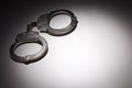 Pair of Handcuffs Under Spot Light - Text Room Royalty Free Stock Photo