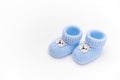 Top view. A pair of handmade blue knitted baby booties, isolated white background. Newborn clothing. Pregnancy. Fashion Royalty Free Stock Photo