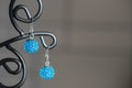 A pair of handmade earrings from beads of turquoise color Royalty Free Stock Photo