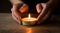 A pair of hands carefully holding a flickering candle, with the warm flame glowing softly Royalty Free Stock Photo