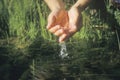 A pair of hands entering a river to get clean water