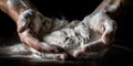 A pair of hands expertly kneads dough, the flour dusting the skin and the strain of the effort visible in the sinews of Royalty Free Stock Photo