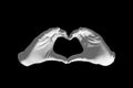 Pair of hands in the form of heart on a black background. love and relationships concept - closeup of hands showing heart shape