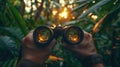 Pair of hands holding binoculars in jungle Royalty Free Stock Photo