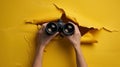 Hands holding binoculars through tear.AI generated image Royalty Free Stock Photo