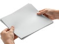 A pair of hands holding a stack of blank white paper sheets against a white background Royalty Free Stock Photo