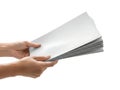 A pair of hands holding a stack of white paper sheets against a white background Royalty Free Stock Photo