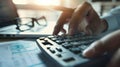 A pair of hands operates a calculator next to eyeglasses and financial documents on a desk..AI generated image Royalty Free Stock Photo