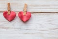 Valentines day background with pair red hearts on clothespins at wooden border. Valentine`s Day concept
