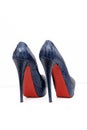 A pair of high-heeled shoes in blue with a red sole Royalty Free Stock Photo