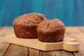 Pair of homemade chocolate cakes on blue background