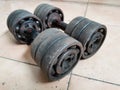 A pair of homemade dumbbells made of iron pipes and bearings