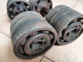 A pair of homemade dumbbells made of iron pipes and bearings