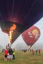 Hot air balloons being inflated with bursts of flame Royalty Free Stock Photo