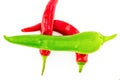 Pair of hot peppers red pods close-up bright contrast with green chile on a white background Royalty Free Stock Photo