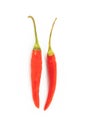 Pair of hot red chili peppers thin pods of a couple of vegetables on a white background isolated