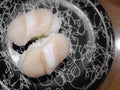 A pair of Hotate sushi, Japanese raw scallop meat on rice