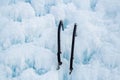 Pair of ice axes on blue wavy ice Royalty Free Stock Photo
