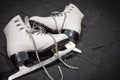 Pair of ice figure skates on black background. Winter sport activity. White ice skates with blade, isolated. Fun and hobby concept Royalty Free Stock Photo