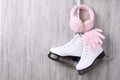 Pair of ice skates, warm earmuffs and gloves hanging on wooden wall, space for text Royalty Free Stock Photo