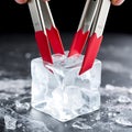A pair of ice tongs gripping a translucent ice block