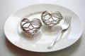 Pair of intertwined silver forks on a dessert plate, Valentine\'s Day. AI Generated