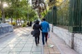 A pair of Iranian couple holding hands and walking in the street of Tehran, Iran