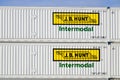 Pair of J B Hunt intermodal containers stacked in closeup with name and logo