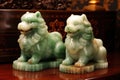 pair of jade fu dogs guarding antique vase