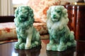 pair of jade fu dogs guarding antique vase