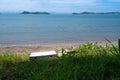 Pair of jandals and empty pizza box left by beach on scenic Man O War Bay on Waiheke Island New Zealand Royalty Free Stock Photo