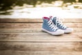 Pair of jeans sneakers on the wood Royalty Free Stock Photo