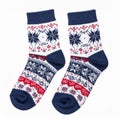 Pair of Knitted Christmas Socks with Snowflake and Geometric Patterns on White Royalty Free Stock Photo