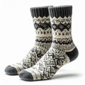 Pair of Knitted Wool Socks Featuring Intricate Geometric Pattern on White Background Royalty Free Stock Photo