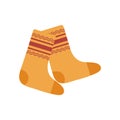 A pair of knitted woolen, warm, orange-yellow socks with an ornament. Winter and autumn accessories for coziness. Flat Royalty Free Stock Photo